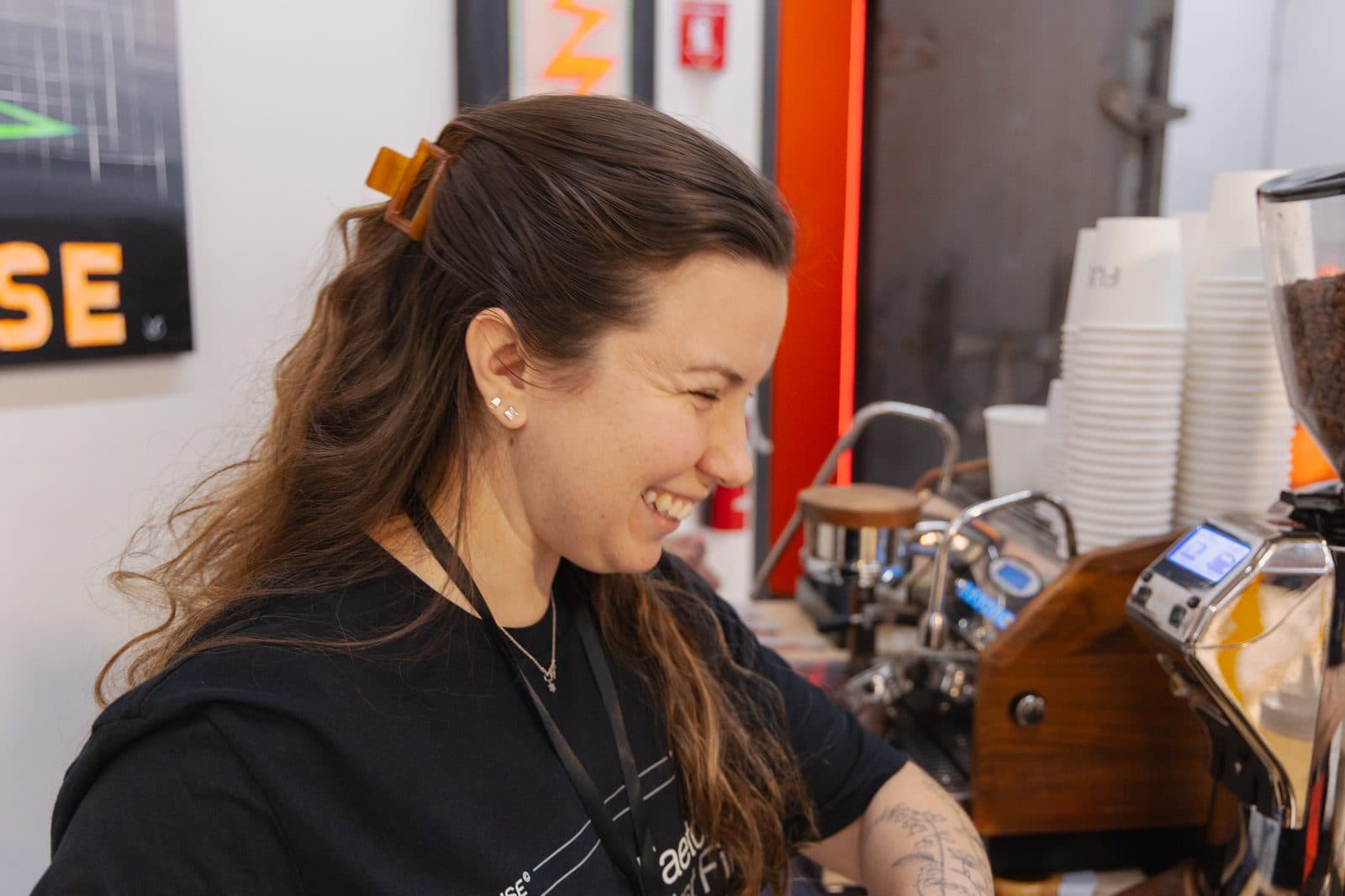 Smiling Motivāt barista at the event espresso machine