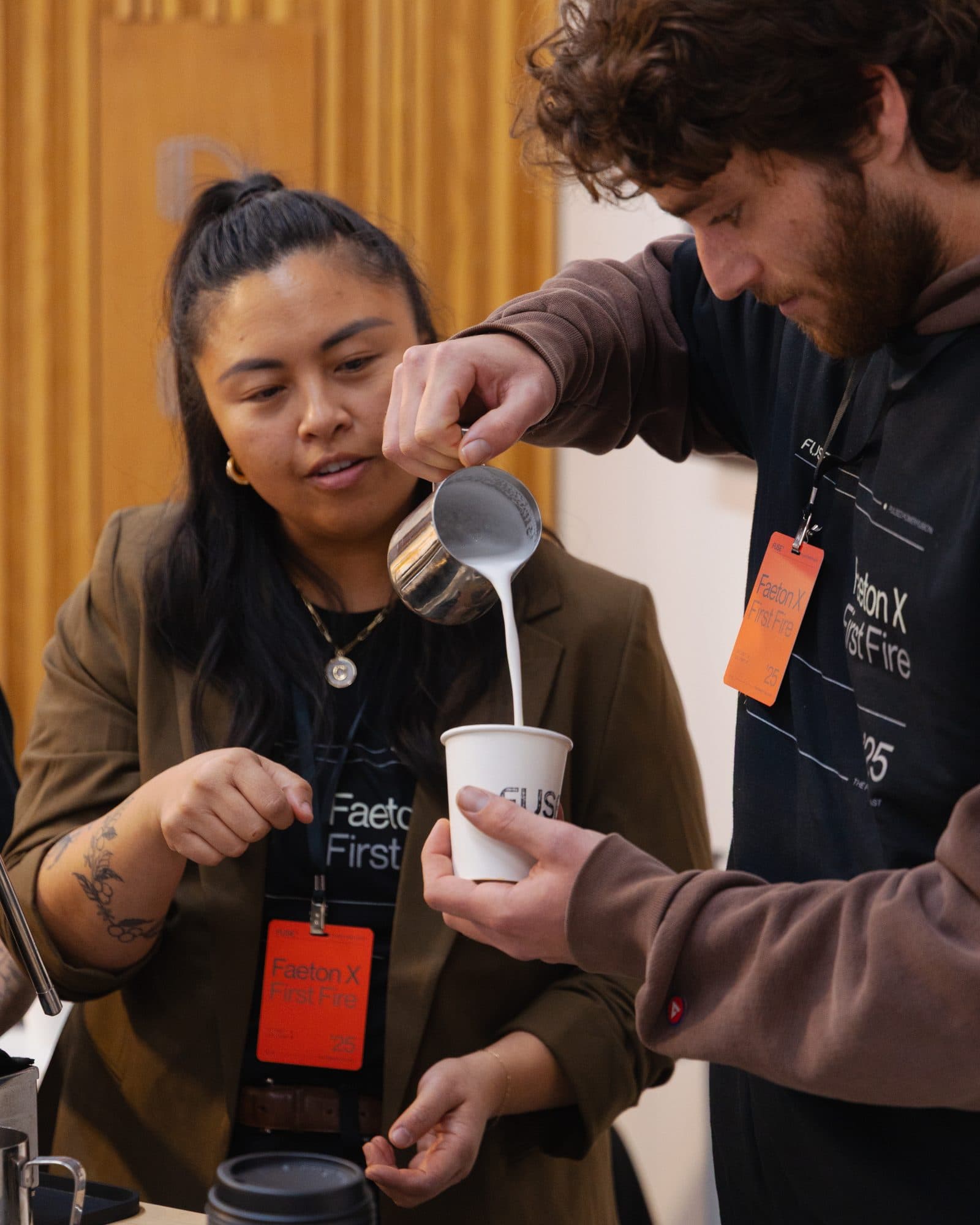 Barista pouring a drink for a guest at the Motivāt cart
