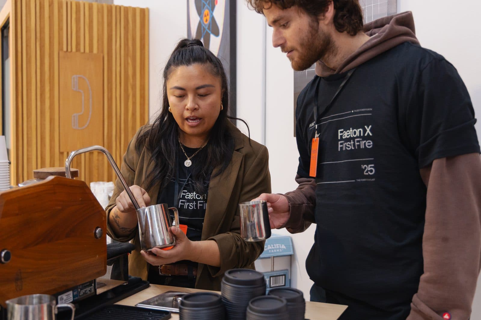 Motivāt baristas preparing drinks side by side at an event