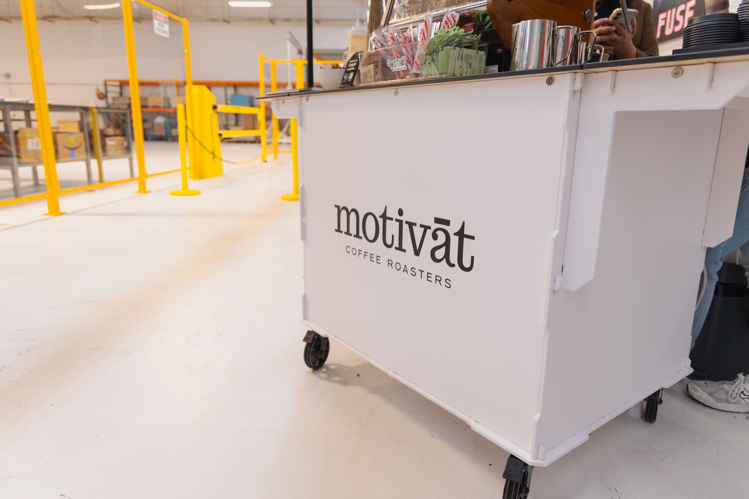 The branded Motivāt coffee catering cart at an event