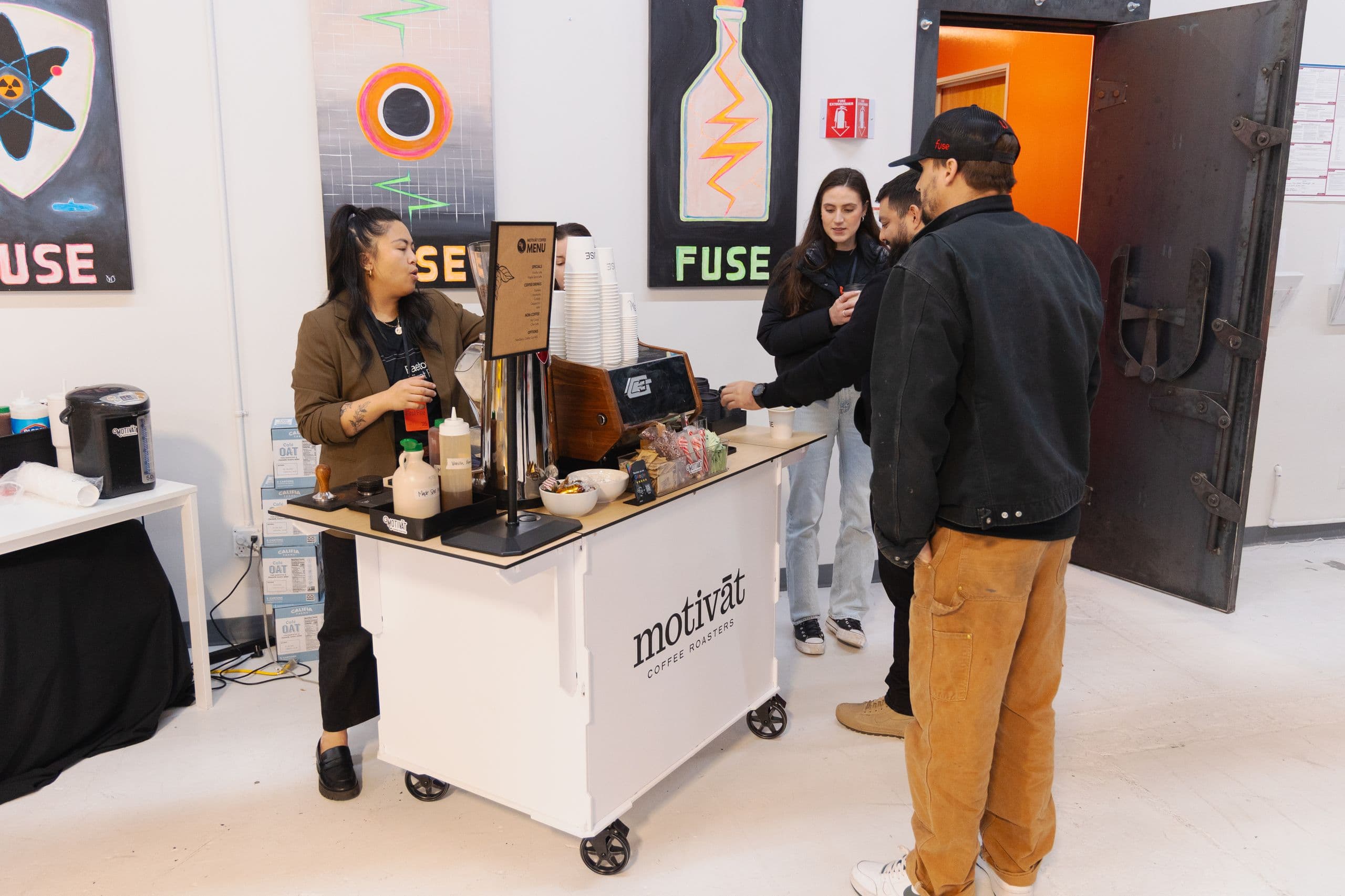 Motivāt barista serving guests from the mobile coffee cart at a Bay Area corporate event