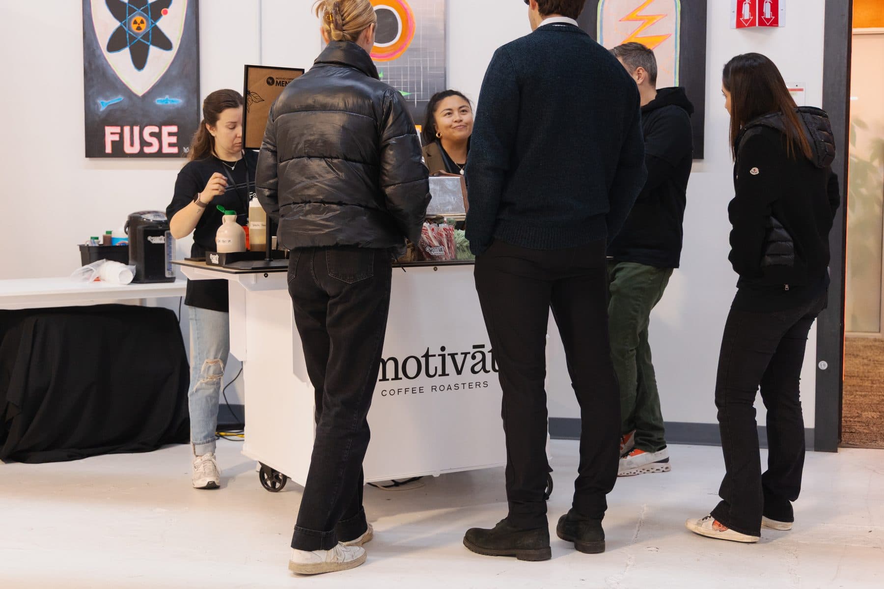 Guests mingling around the Motivāt cart at a corporate event