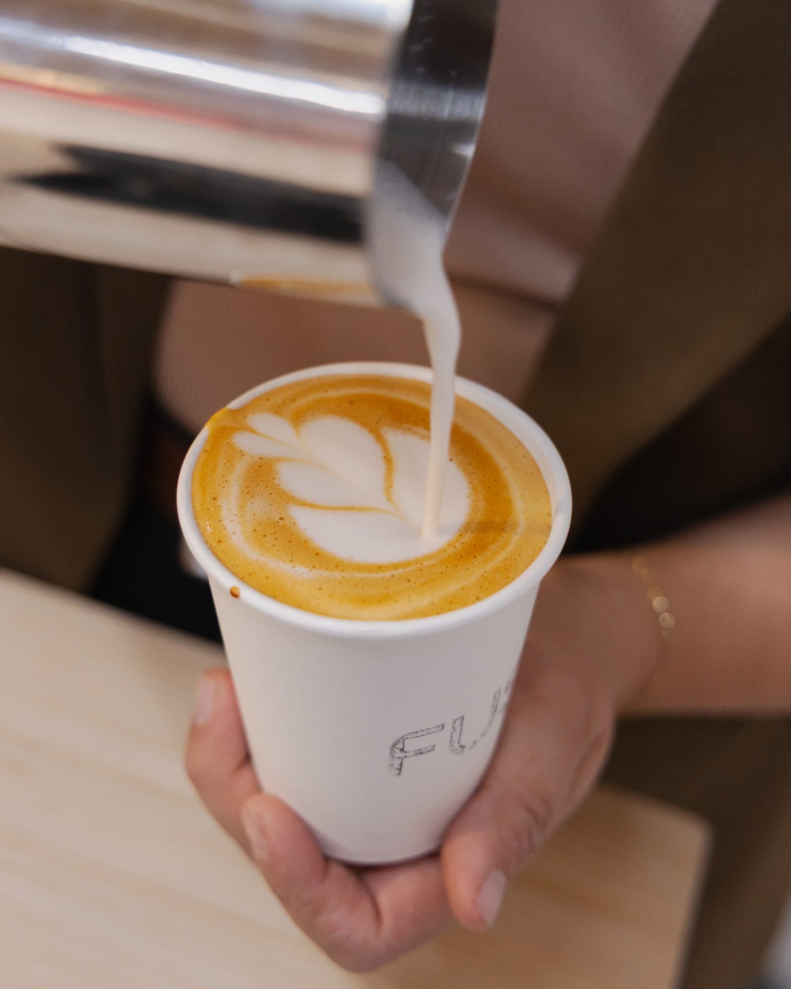 Latte art poured at a Motivāt catering event